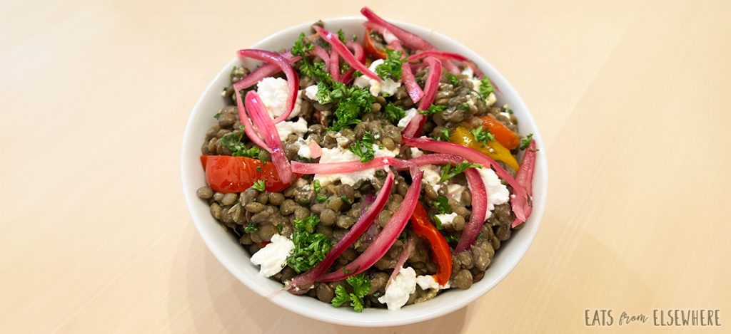 Lentil salad with goat cheese, roasted peppers, and pickled onions