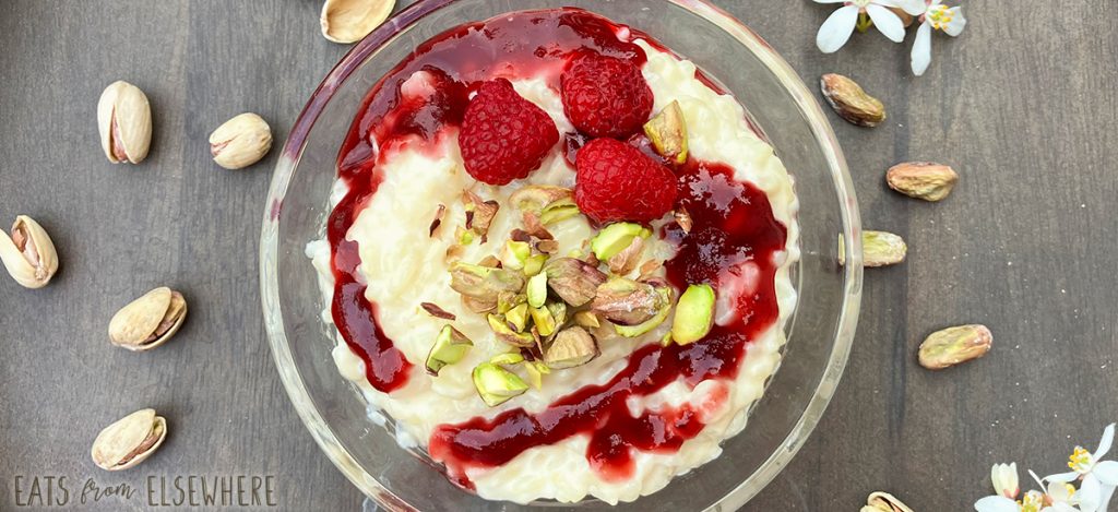 orange blossom rice pudding with pistachios and raspberry coulis